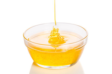 bowl of honey isolated on white background