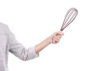 Woman hand holding whisk isolated on white background.