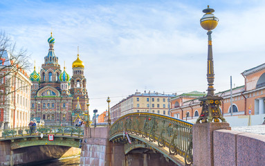 : The scenic old fashioned streetlight on Malokonushenny bridge with the Church on Spilled Blood on...