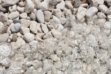 background with pebbles and sea wave