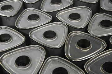 Industrial background. Stacks of new exhausts and silencers mufflers car before distribution and retail. Detail of a new automotive components in stainless steel. Close up.