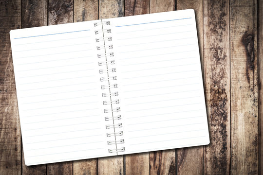 Open notebook paper with line on wood background for design with copy space for text or image.