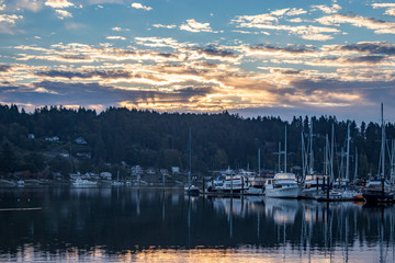 Fototapeta na wymiar Boats at harbor under golden morning sky