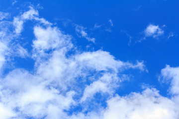 Blue sky background with white clouds. The vast blue sky and clouds sky on sunny day. White fluffy clouds in the blue sky.