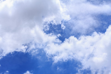 Blue sky background with white clouds. The vast blue sky and clouds sky on sunny day. White fluffy clouds in the blue sky.