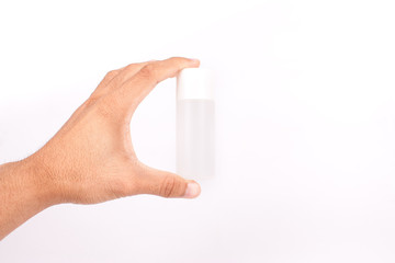 Man hand holding a small tube cream on white background