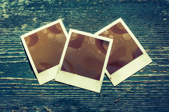 Set of photo frames with age created abstract photos isolated on wooden background. Photo frame for your object. Copyspace included.