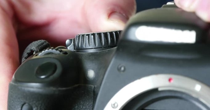 closeup view of a finger pushing the release button of a professional digital slr camera