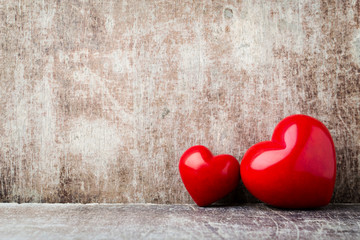 Heart. Red stone hearts on the wood background.