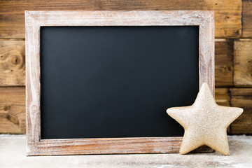 Christmas chalkboard with decoration. Santa hat, stars,  Wooden