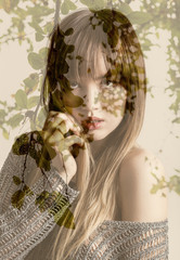 Double exposure of beautiful girl and green leaves