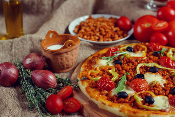 Pizza bolognese on a wooden board.