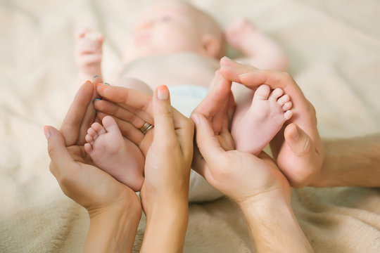 Newborn feet in parents hands