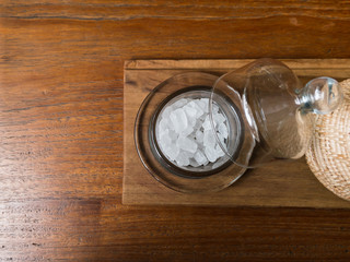 rock sugar in glass bottle on wooden table