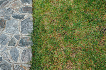 Stone wall and green grass