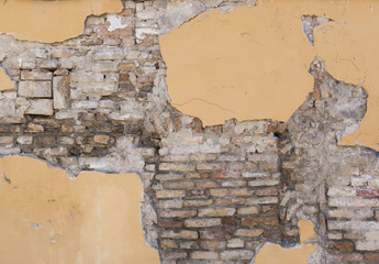 Background texture from brick wall with damaged cracked plaster