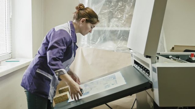 industrial printing process - worker monitors print quality