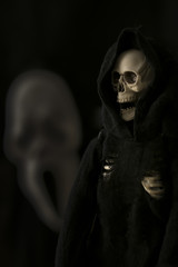 grim reaper, Halloween death character against black background with scream face