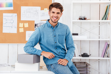 Man sitting on the office desk with boxes