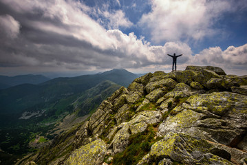 Fototapeta premium Mountain landscape and self portrait from hill Chopok in Low Tatras at Slovakia. Dramatic cloudy sky during summer day at mountain peak.