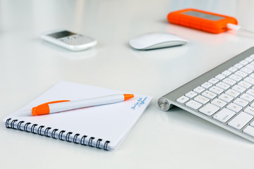 Business Composition on white Table orange Items