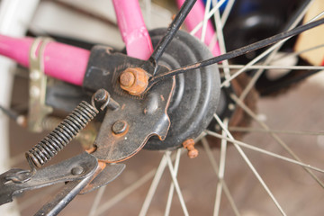 Fototapeta na wymiar Rust gear and wheel of pink bicycle background