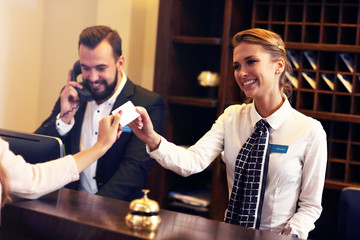 Fototapeta Guests getting key card in hotel obraz