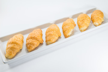 Mini whole wheat croissants in a with ceramic dish for healthy