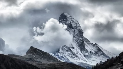 Fotobehang Majestic Matterhorn Mountain in Clouds, the symbol of the Swiss Alps. © Rashevskyi Media