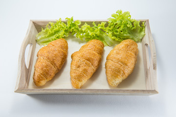 Mini whole wheat croissant with green oat in a wood dish for healthy