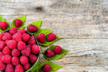 Fresh raspberries summer fruits on wooden background