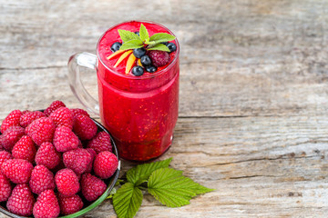 Raspberry cocktail in a glass jar, drink with fresh berries