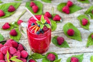 Raspberry cocktail in a glass jar, drink with fresh berries