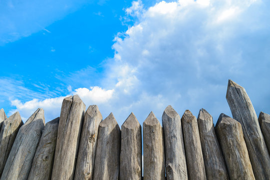 wooden palisade on the background of blue sky