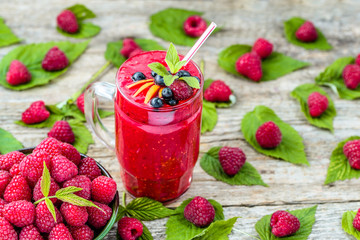 Berry smoothie from raspberry fresh fruits on wooden table
