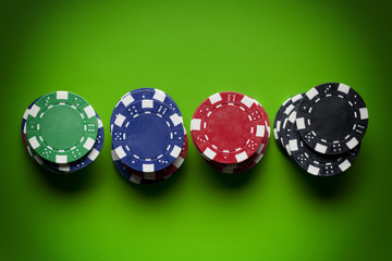 Colored poker chips on green table