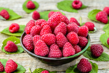 Fresh raspberries summer fruits close view in a bowl