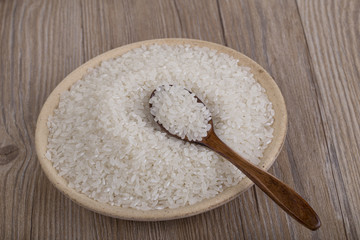 Rice in wooden plate  on the table for food background