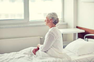 senior woman patient lying in bed at hospital ward