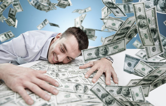 happy businessman with heap of money