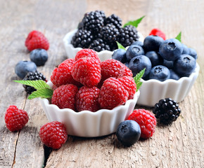 Mix of berries on wooden board.