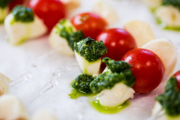 close up of mozzarella and cherry tomato canape