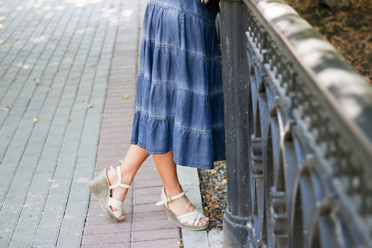 A Long Denim Skirt And Women's Legs