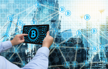 Cryptocurrency, blockchain and bitcoin concept. Distributed ledger technology. Man holding tablet , block chain and bitcoin icons with smart building background. Blue tone