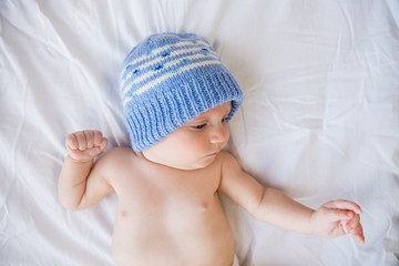 Cute baby boy relaxing on bed
