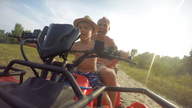 4K footage:  son with father riding by the quadrocycle front camera view