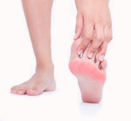 Foot pain in women, Woman massaging her foot.