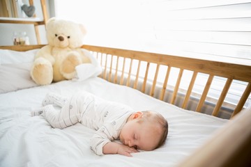 Baby boy sleeping on a cradle