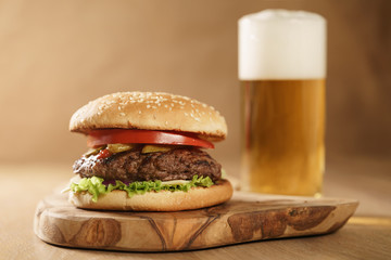 fresh homemade burger with beer on olive board