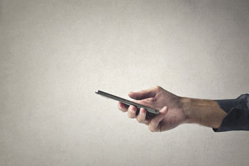 Naklejka premium Holding a smartphone